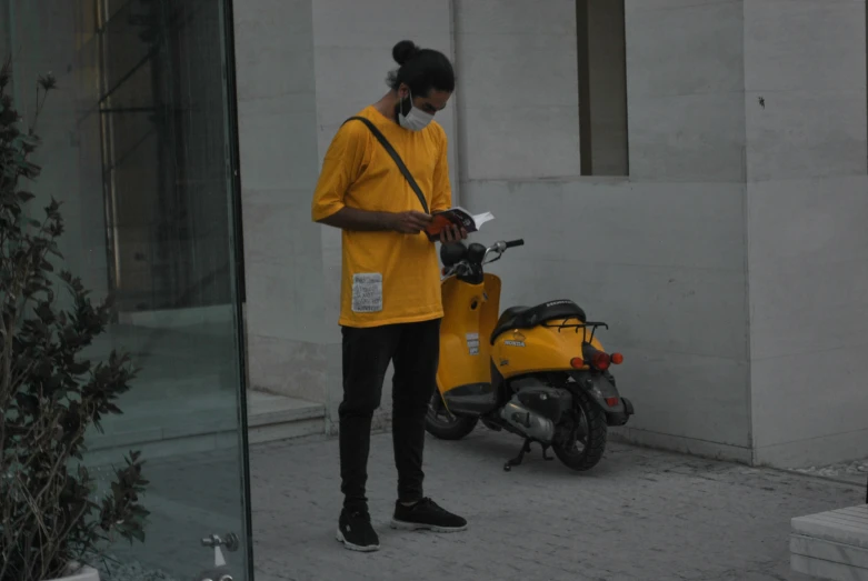 a woman is standing next to a motorcycle