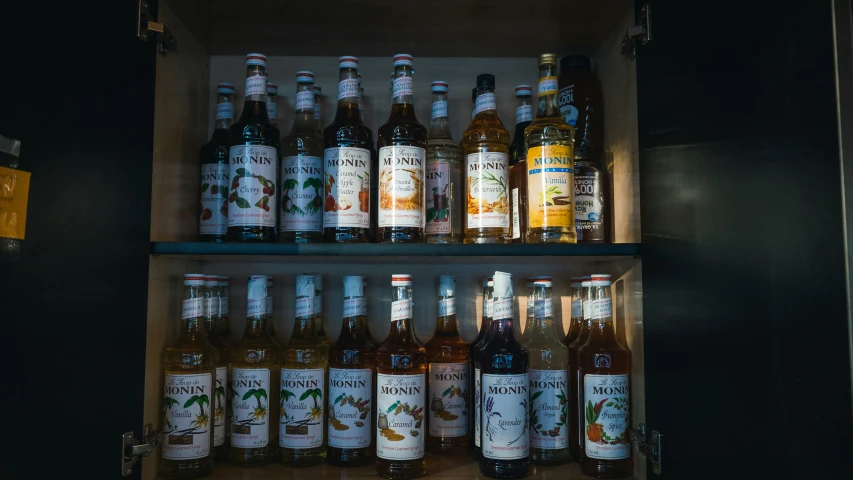 an open refrigerator filled with bottles of alcohol