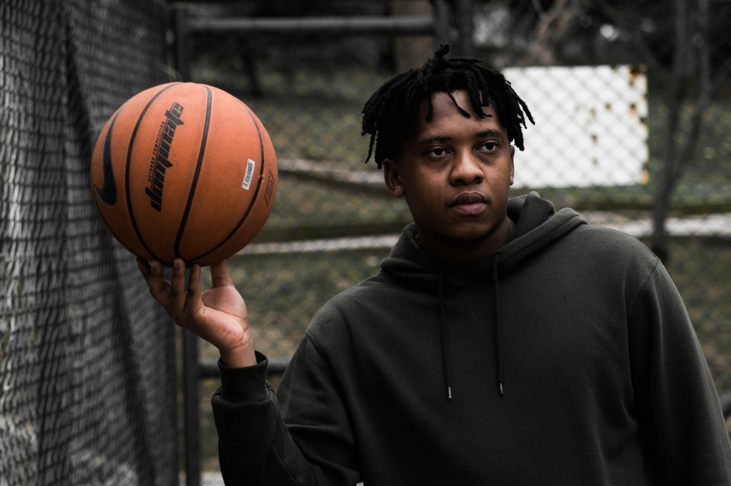 a boy holding a basketball in his hand