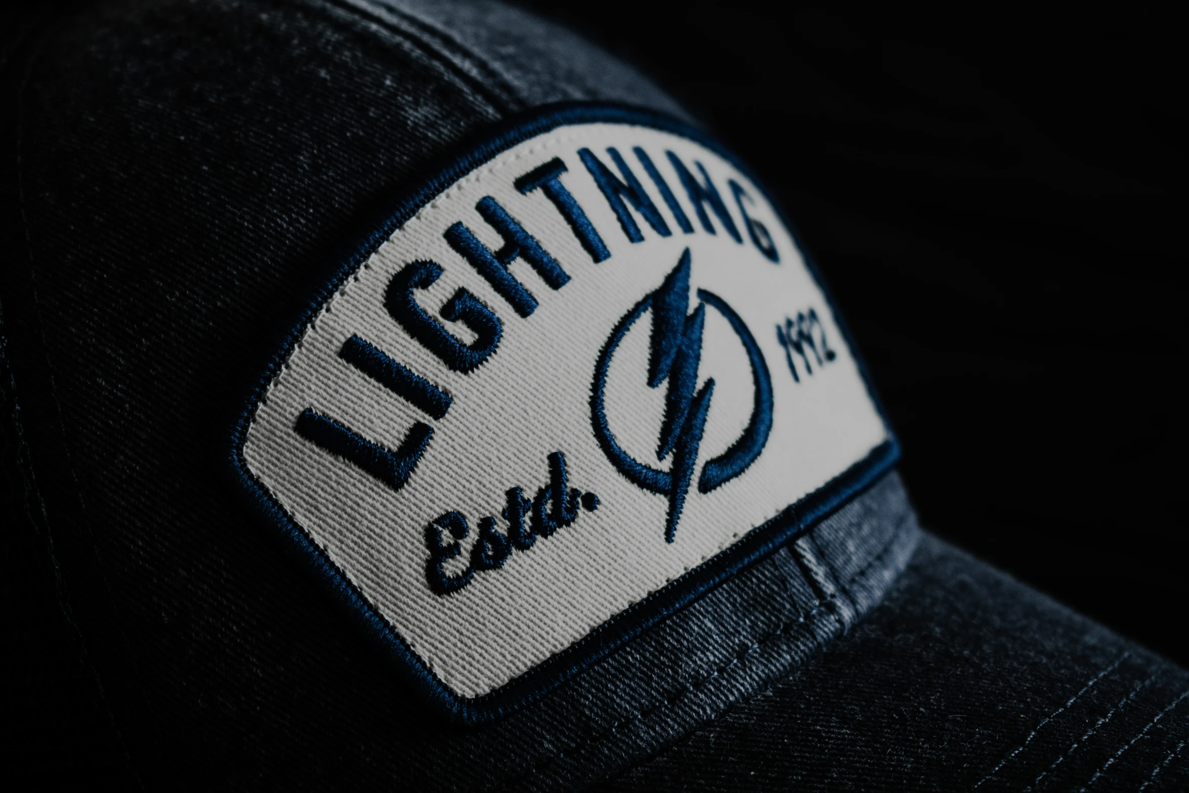 the cap is showing the lightning emblem on it