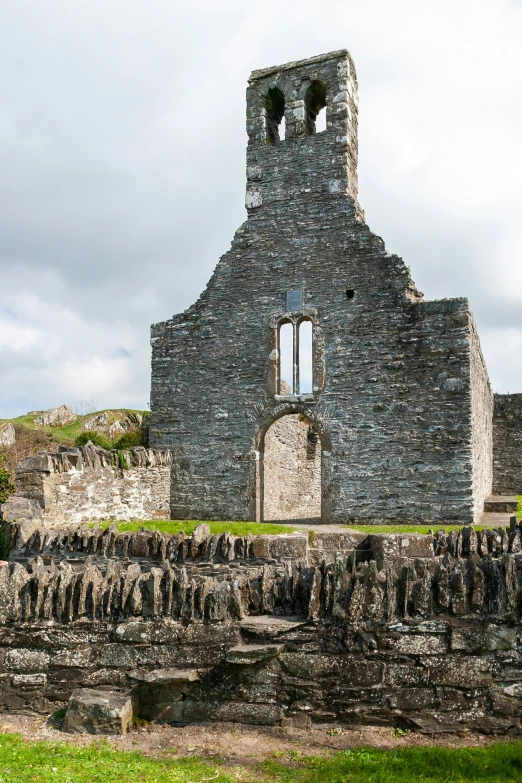 a stone building with a clock tower at the top