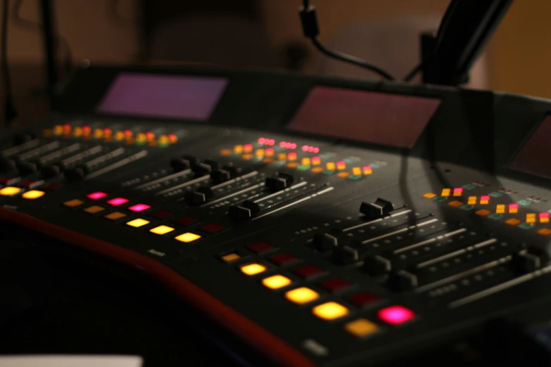 a close up of a mixing console with a multi color on