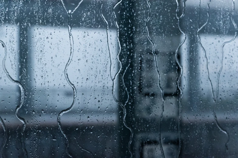 rain fell on the window as it reflects the sky