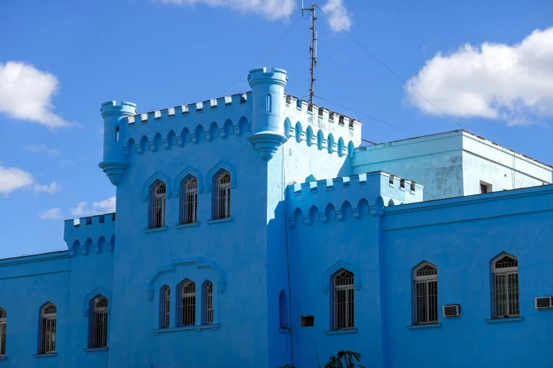 a tall building that is blue with some windows on it