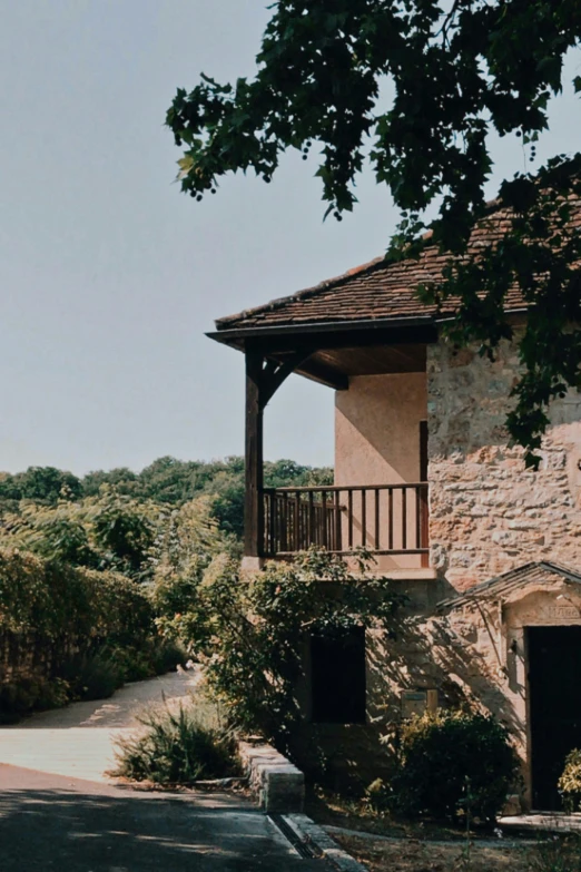 a view of an old building with a fence on the second floor