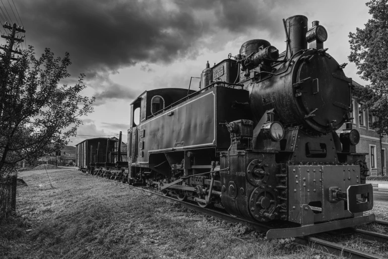 an old steam engine is parked on the train tracks