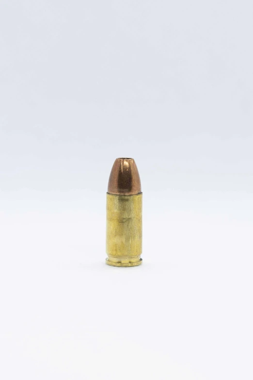 a gold bullet on a white background