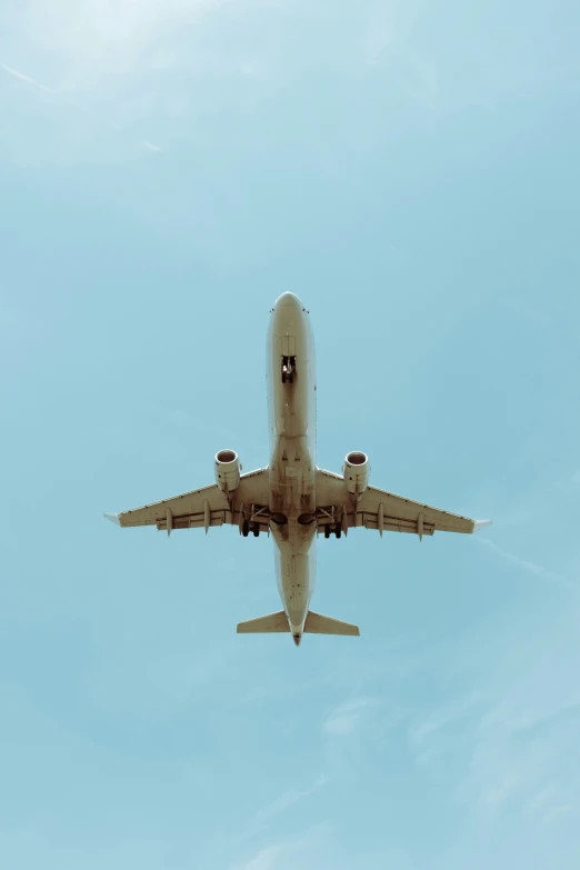 an airplane flying through the air on a cloudy day