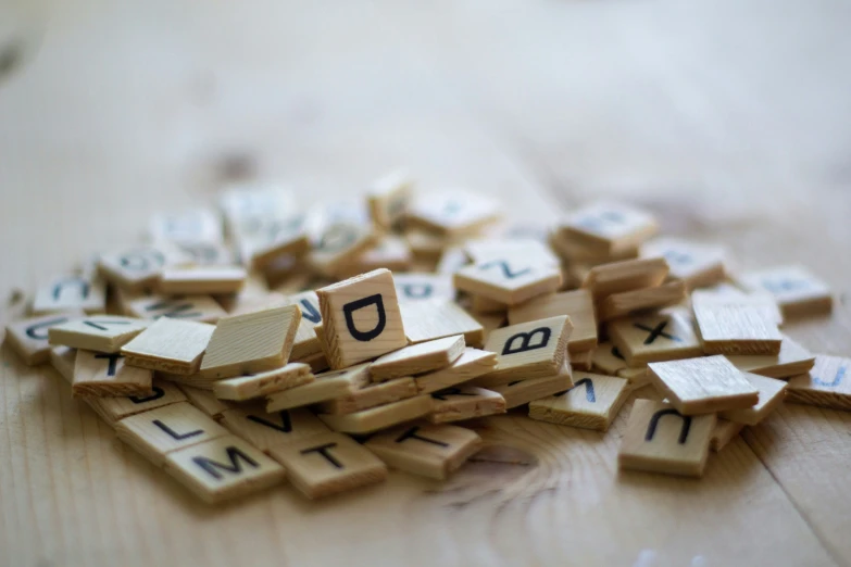 several alphabet letters are laid out on top of a wooden table