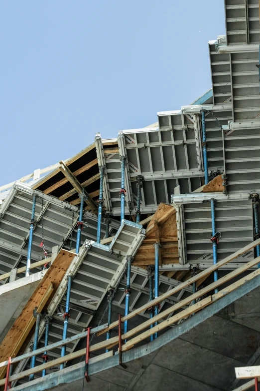 several metal staircases sitting under an incomplete building