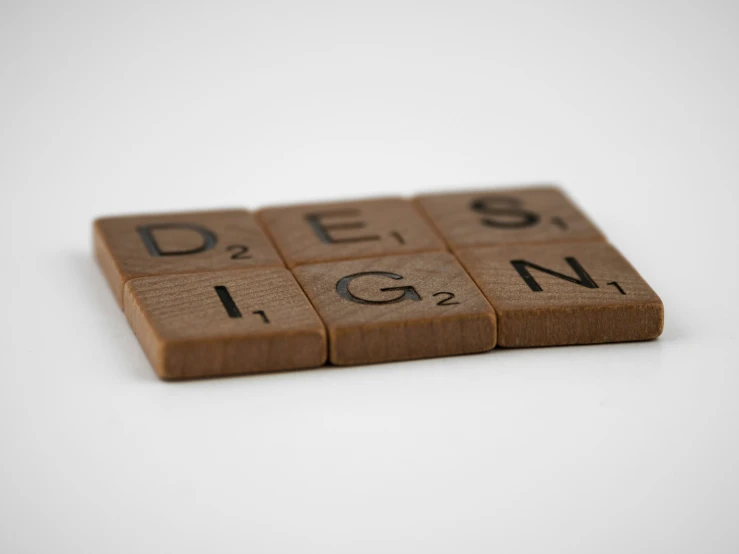wooden letters spelling out design sitting on top of a table
