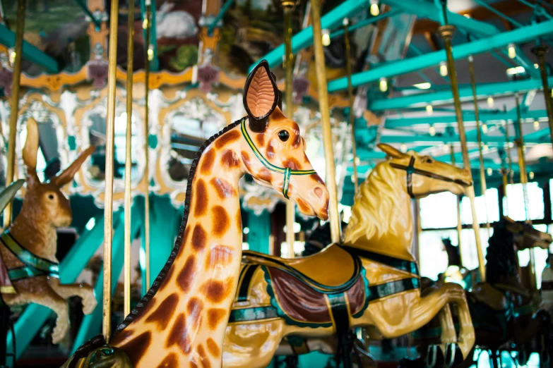 the carousel has several horse heads in front