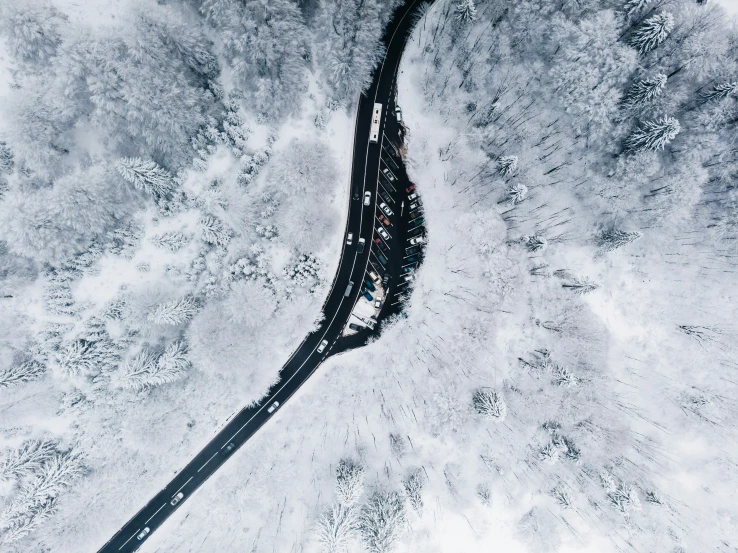 a snowy aerial view shows a road and street