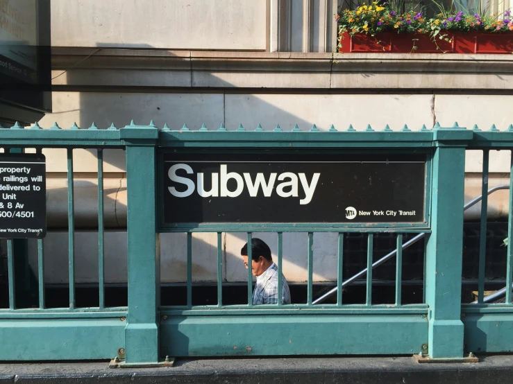 there is an old subway sign inside the fence