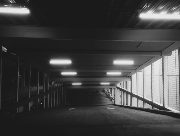 an empty parking garage with multiple lights