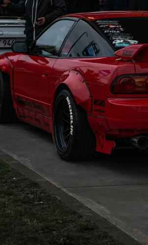 the rear of a red car that has no wheels