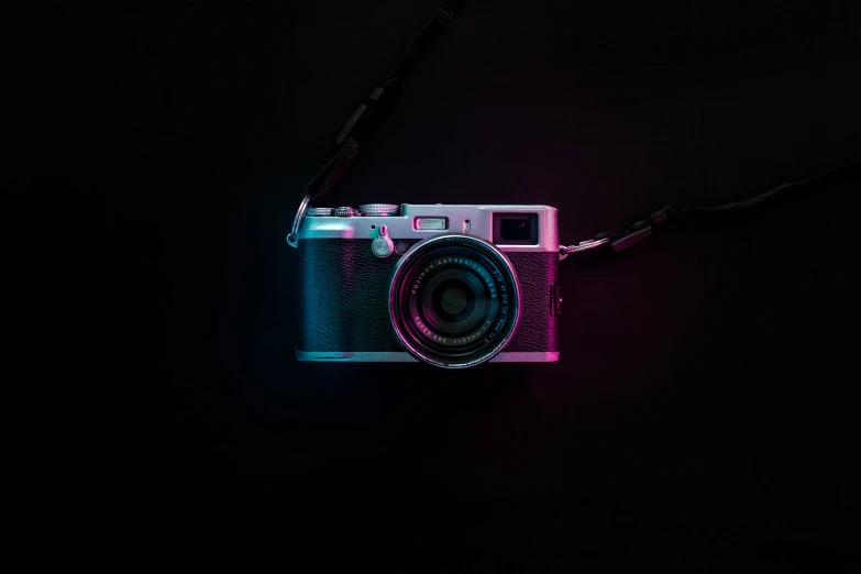 a camera sitting in the dark, with a light shining on it
