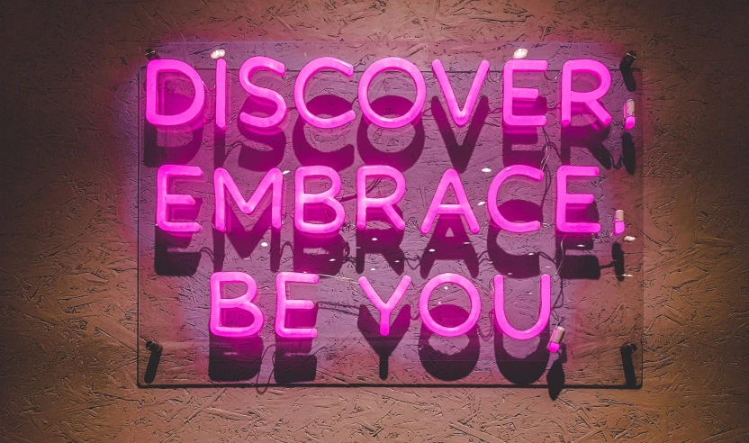 a sign with pink neon on it stating you are very discolored