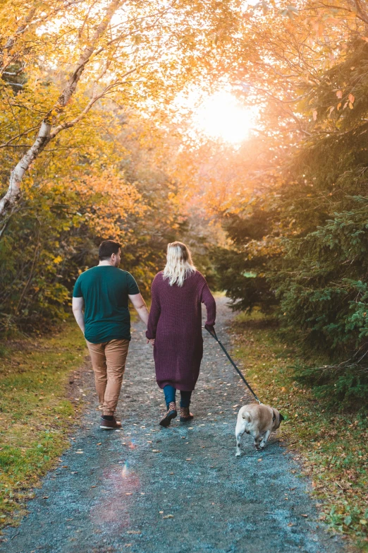 a couple of people walking down a small path