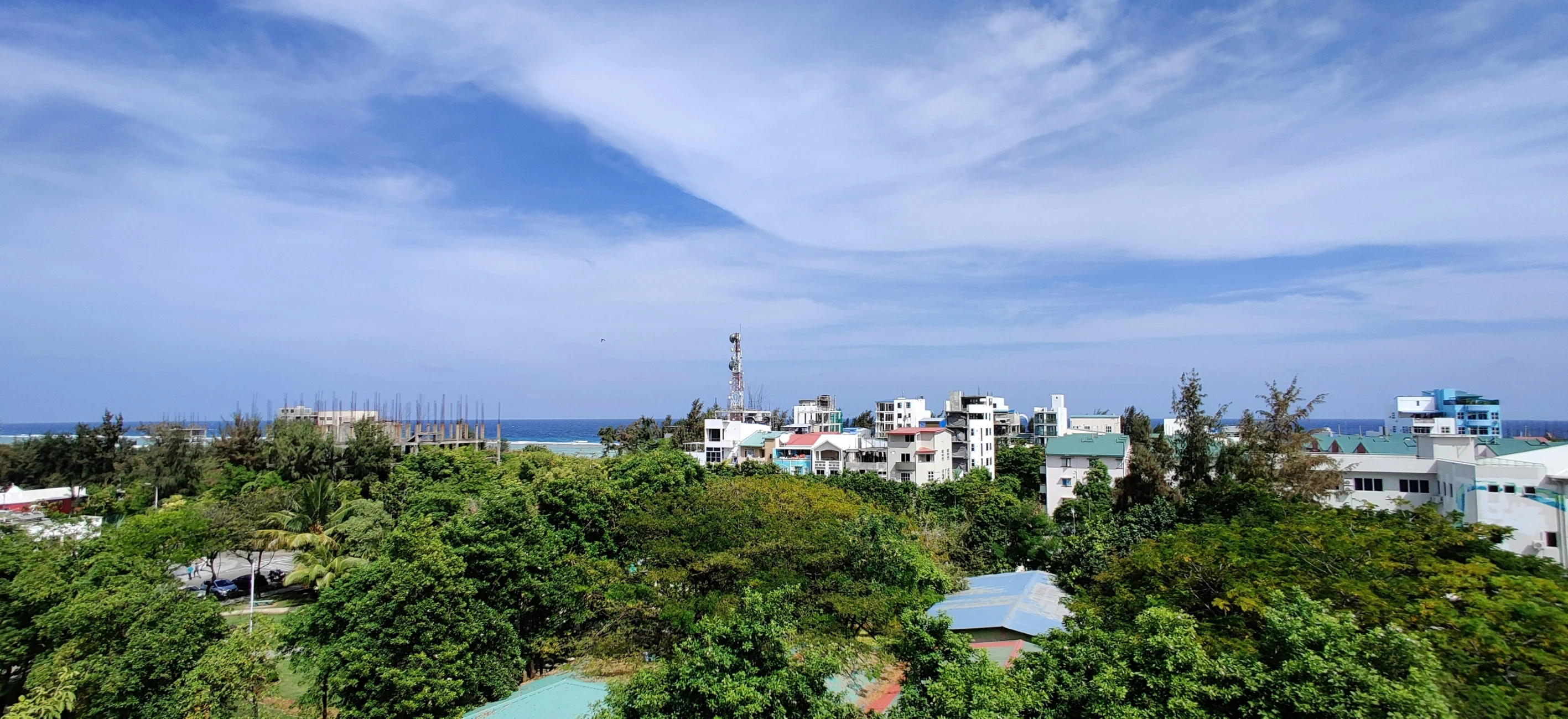 some buildings and trees in front of a blue sky