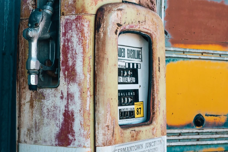 the rusty old gas pump on an abandoned bus