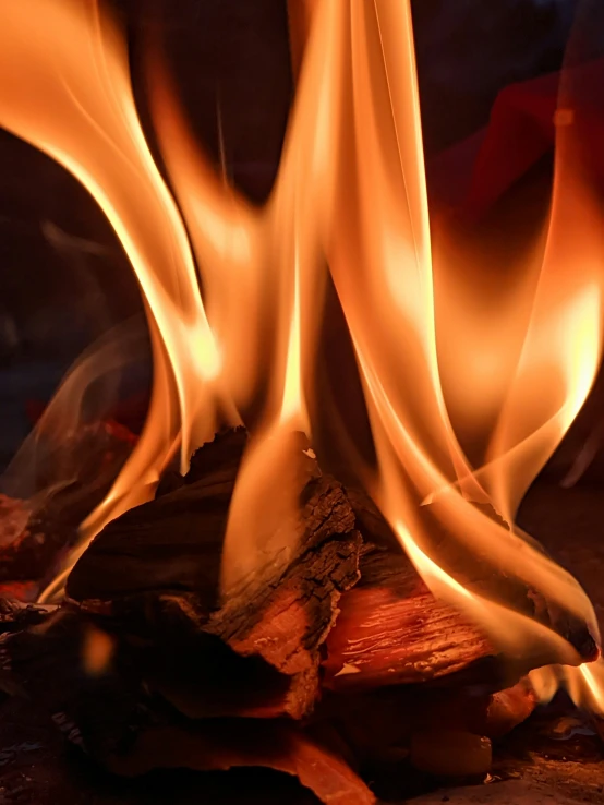 a close up of a flame near a dark background