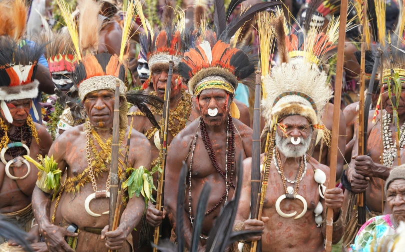 native indian men wearing headdress and masks