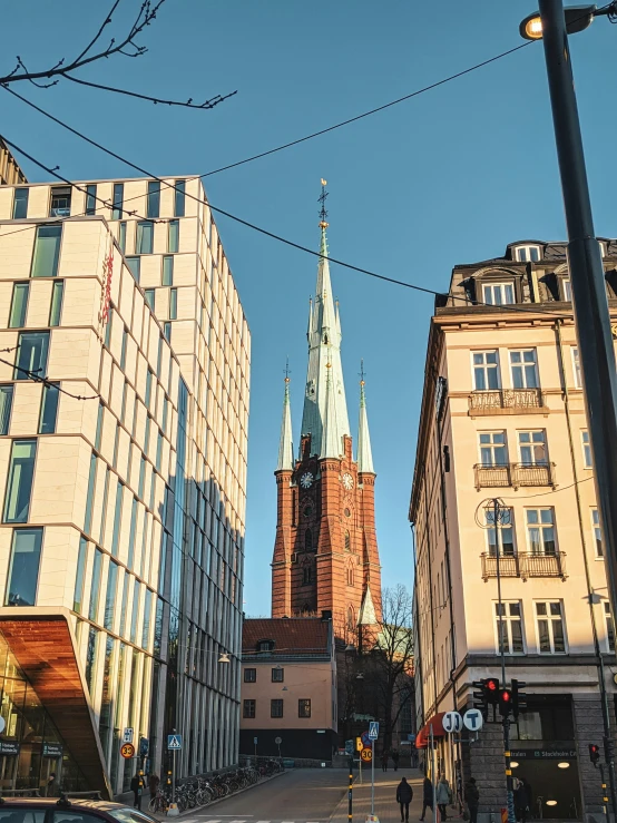 two buildings and a very tall church tower