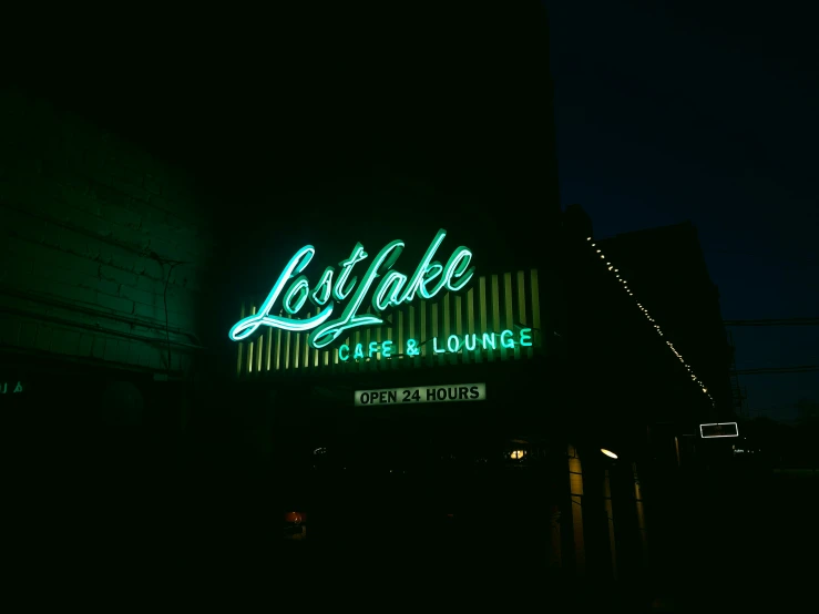 the building has a neon sign in the dark