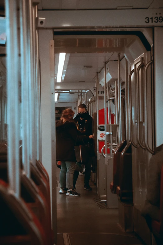 a couple of people walking down a train