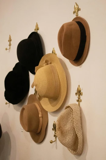 six hats hang on the wall