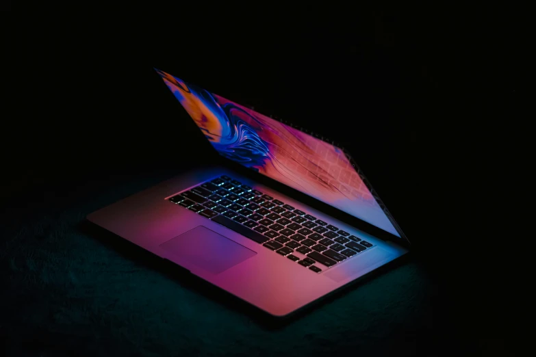 a bright laptop with dark background and blue light
