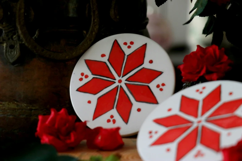 red flowers, decorative objects, and vase on wooden table