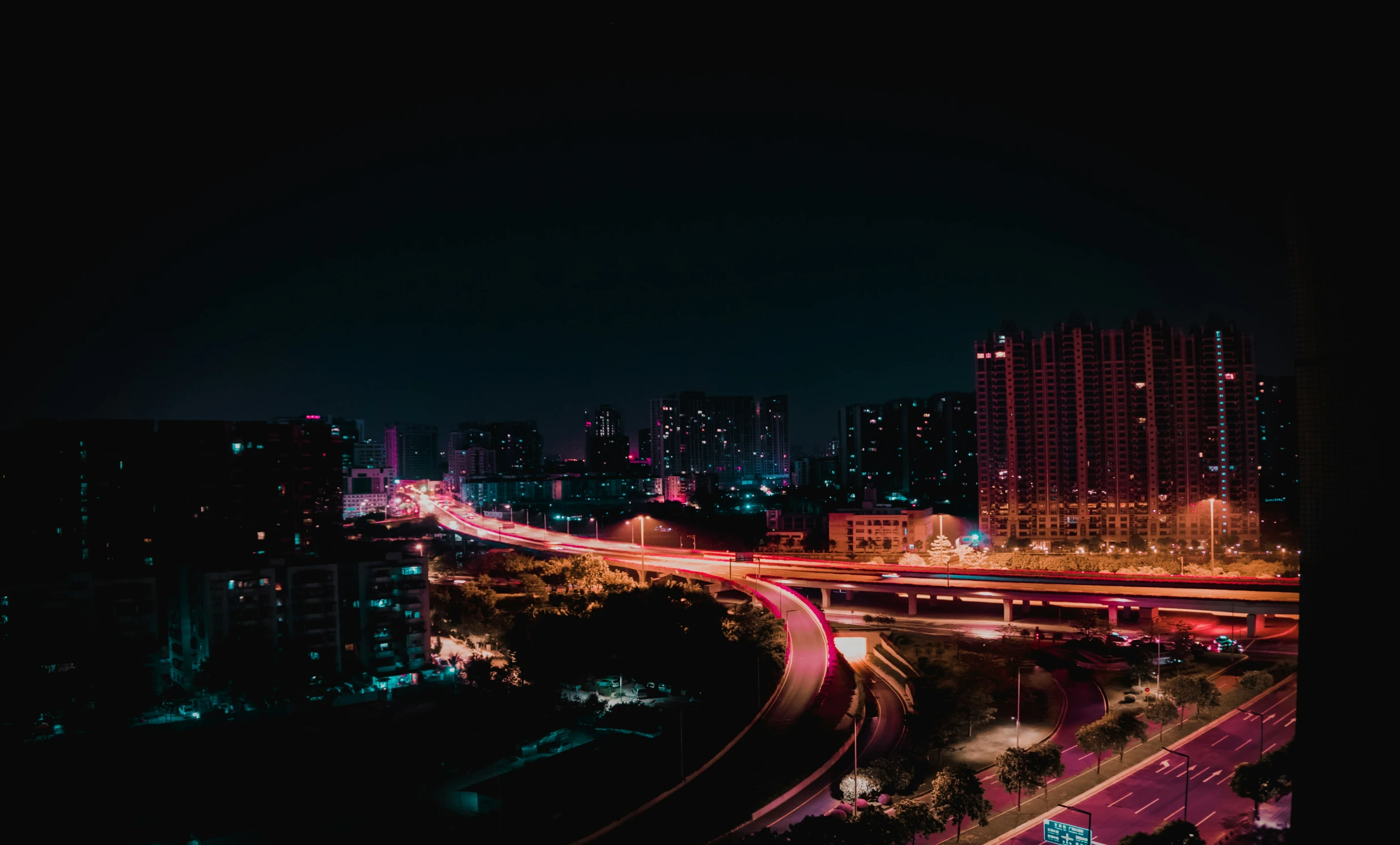 an aerial po at night of a freeway intersection in a city