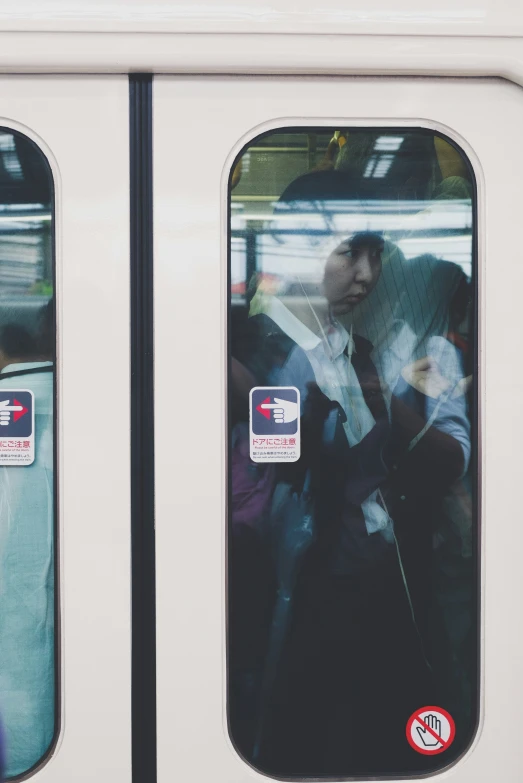 commuters stand in the passenger compartment of a subway train