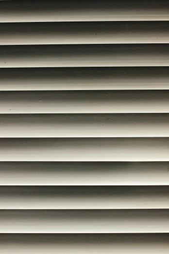 a close up of many horizontal blinds on a wall
