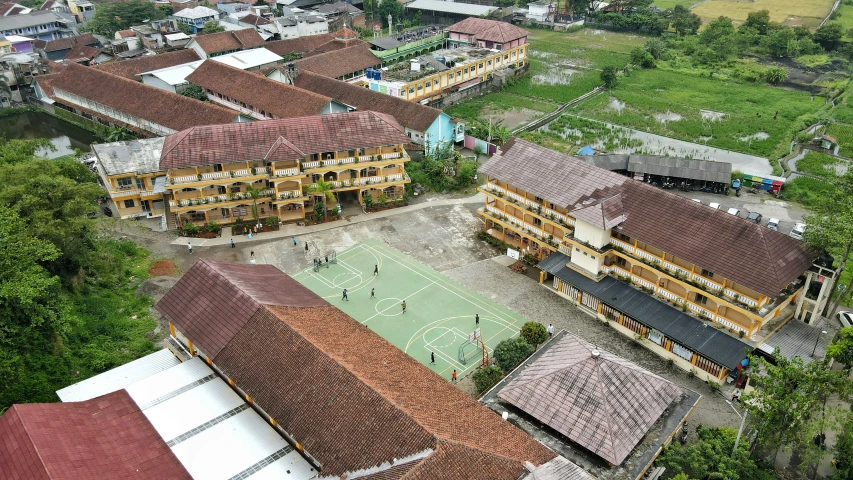 an aerial view of a school and basketball court