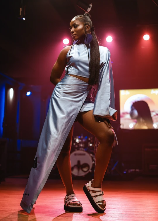 a person standing on a stage with shoes in the air