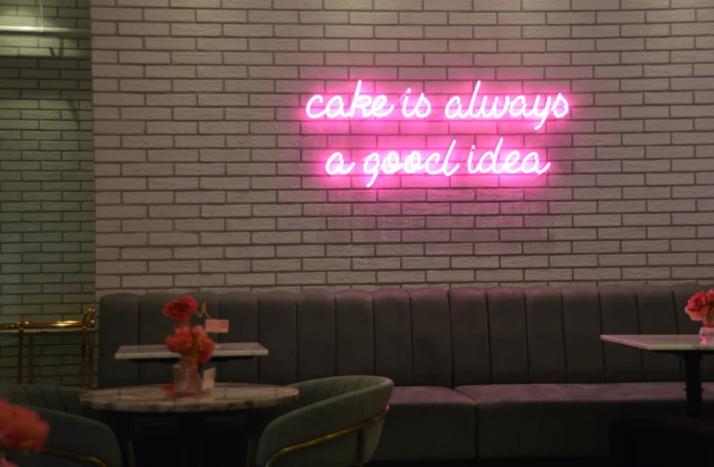 there is a wall with a neon sign in the middle