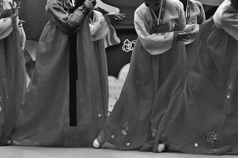 black and white pograph of people standing in front of a mirror