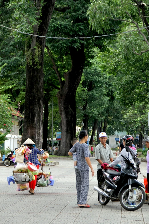 some people with their bikes are standing by some trees