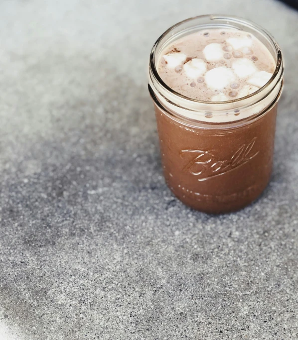 a mason jar with brown liquid on it