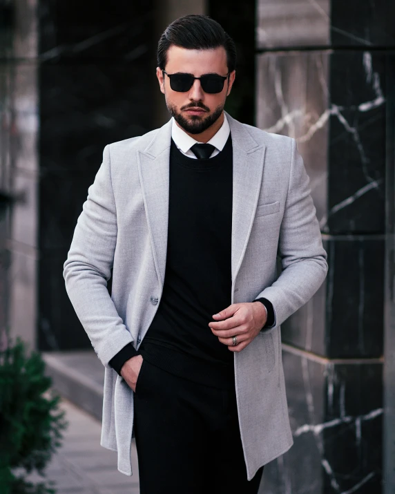 a man wearing sunglasses and a tie with a suit