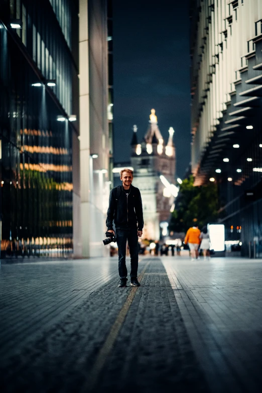 a man walks through a city at night