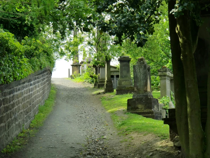 a trail leading to the cemetery with stone headstones