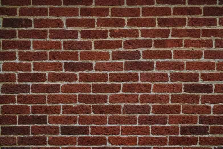 a brick wall with a small red clock