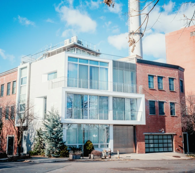 this modern residential building is featured against a blue sky