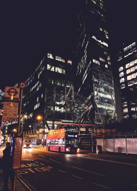 night view of tall buildings in the city with traffic