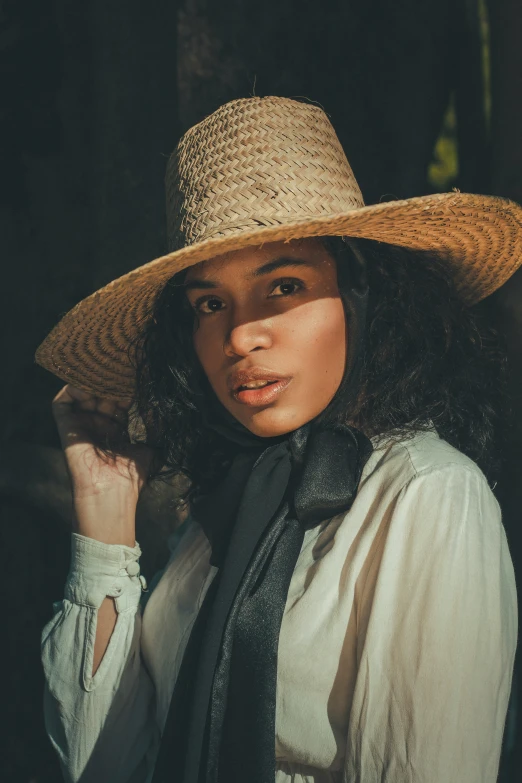 woman wearing a long tie and a big hat