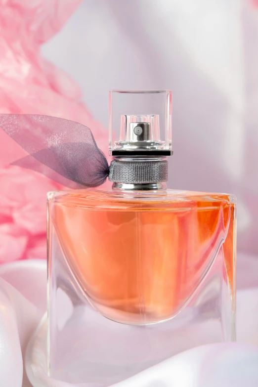 an unopened pink perfume bottle sitting on a table